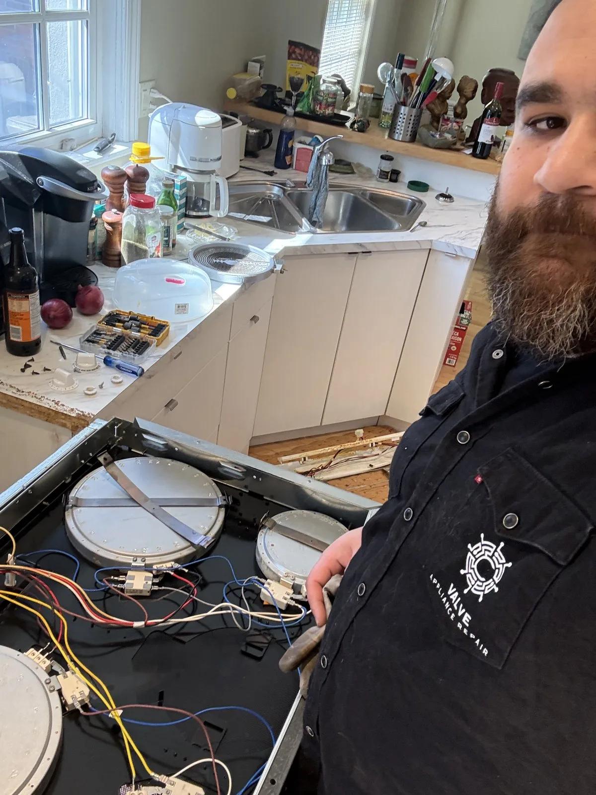Valve technician performing cooktop repair