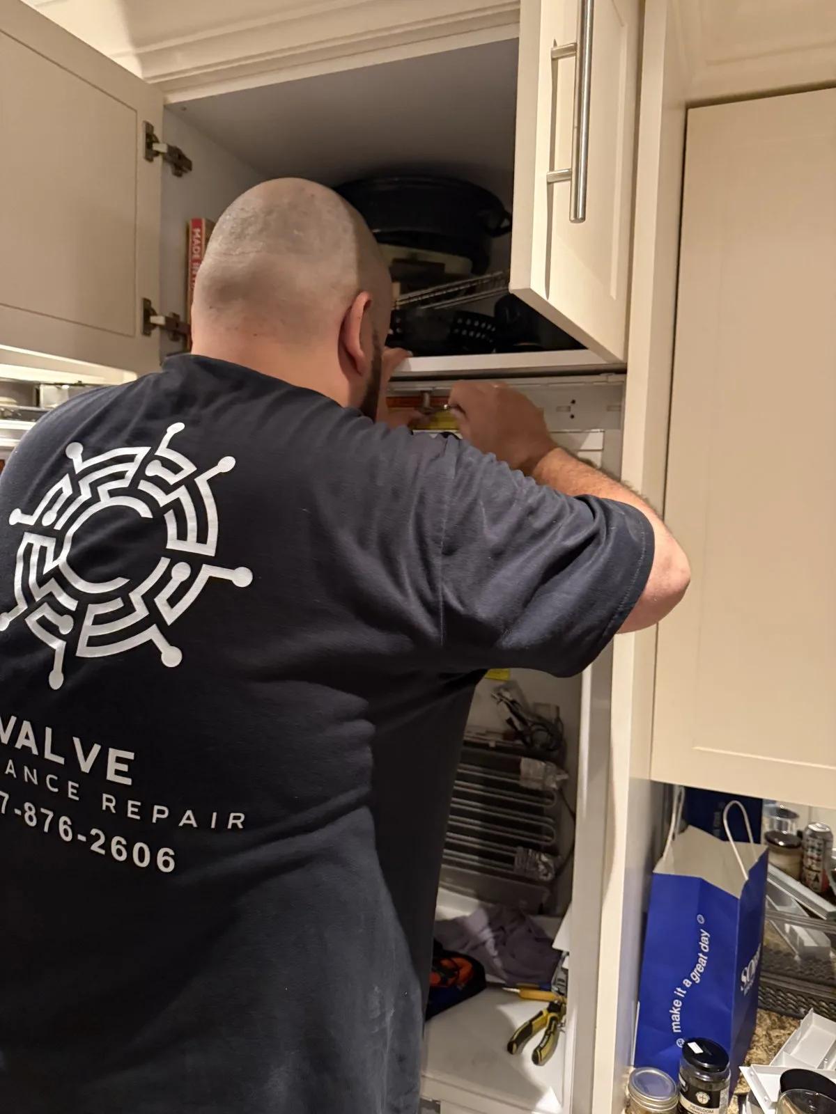 Valve technician performing refrigerator repair